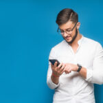 businessman using mobile phone app texting blue