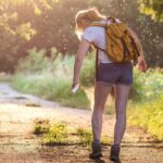 a hiker spraying for bugs