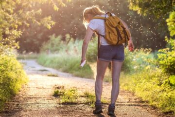a hiker spraying for bugs