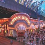 Entrance to the Golden Nugget Hotel and Casino at nighttime with a crowd lined up