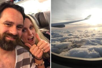 a couple takes a selfie on the plane, a view of the clouds from a plane window