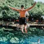 a man goes cliff diving in tulum, mexico