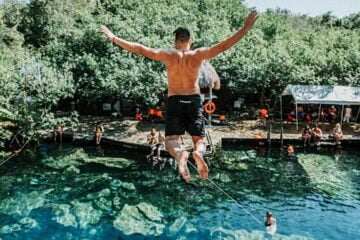 a man goes cliff diving in tulum, mexico