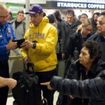 TSA agents and passengers at airport security
