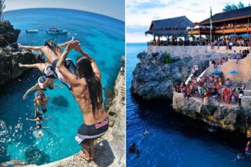 Tourists cliff jump into ocean/ crowd at Rik's Cafe in Negril, Jamaica