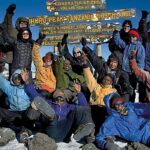 reaching the summit of mount kilimanjaro
