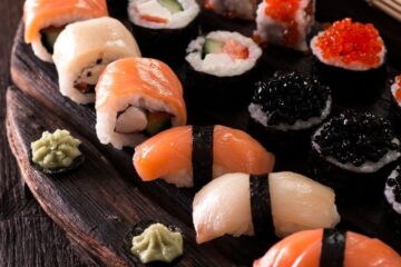 a platter full of mixed sushi