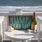 a sign at a vacation rental that says 'welcome to our little piece of paradise'
