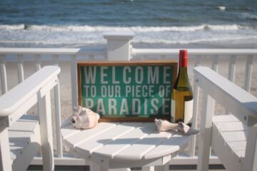 a sign at a vacation rental that says 'welcome to our little piece of paradise'