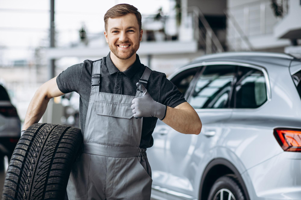 workman car repair shop changing tires