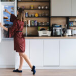 hungry woman looking food fridge home dont have much there white kitchen furniture home wear red silk robe